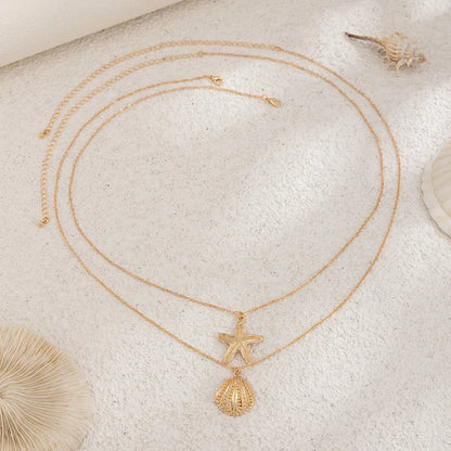 Chaîne de taille bohème d'été, pendentif en forme d'étoile de mer, coquillage, lien de taille ajouré, chaîne de corps pour bikini de plage pour femmes